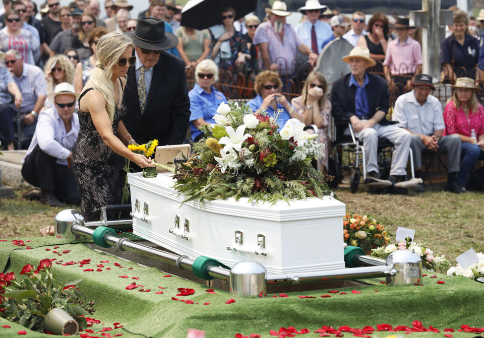 Patrick Salway's wife Renee places a sunflower on the coffin at his funeral. Source: AAP