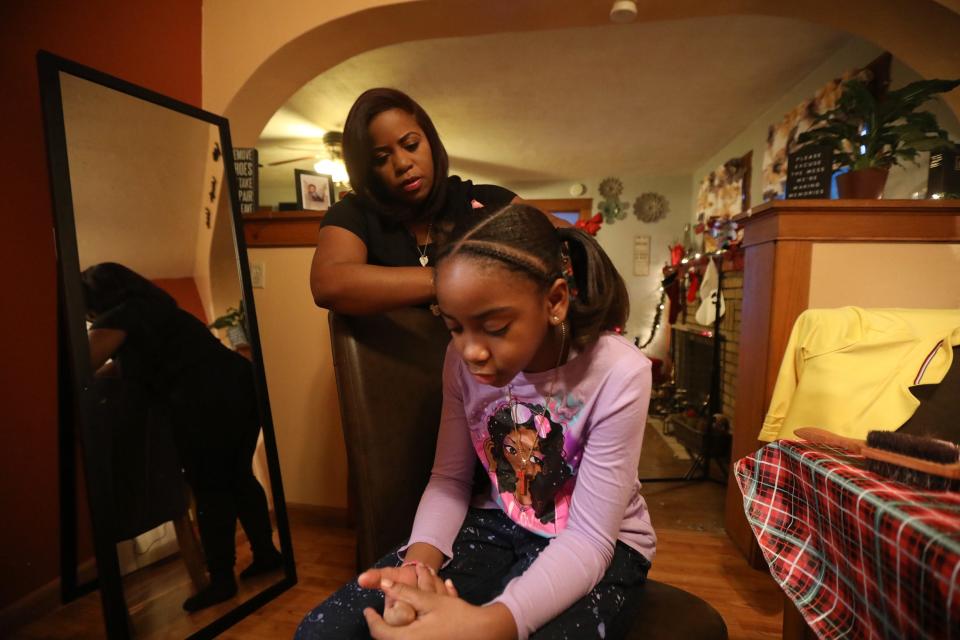 Davette Wright  puts up her daughter, Dakota Ruffin’s hair at  their Hewitt St. home in Buffalo before school, Jan. 13.  