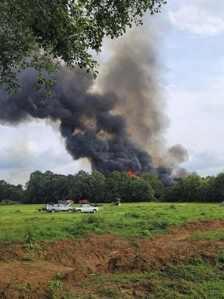 Smoke and fire fill the air from a blaze at National Salvage and Services Corp., on Monday, Aug. 2, 2021 near Selma, Ala. The fire that apparently started with a lightning strike and grew so large it showed up on weather radar engulfed a pile of thousands of railroad ties at a recycling plant in rural west Alabama. (Lane Frazer via AP)