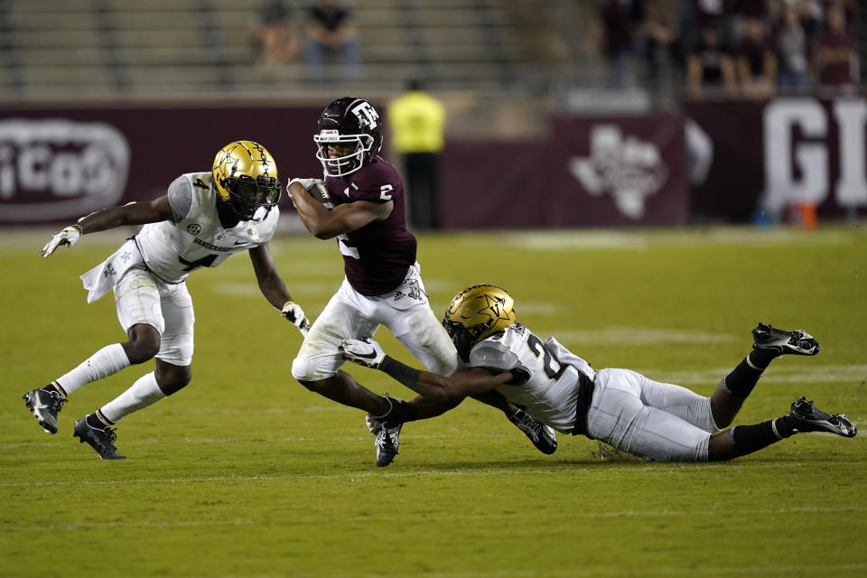 Texas A&M's Chase Lane (2) is tackled by Vanderbilt's Jaylen Mahoney (23) as Randall Haynie (4) helps defend during the second half of an NCAA college football game Saturday, Sept. 26, 2020, in College Station, Texas. Texas A&M won 17-12. (AP Photo/David J. Phillip)