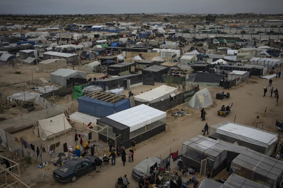 Palestinians displaced by the Israeli ground offensive on the Gaza Strip set up a tent camp in the Muwasi area Thursday, Dec. 7, 2023. AP Photo/Fatima Shbair)