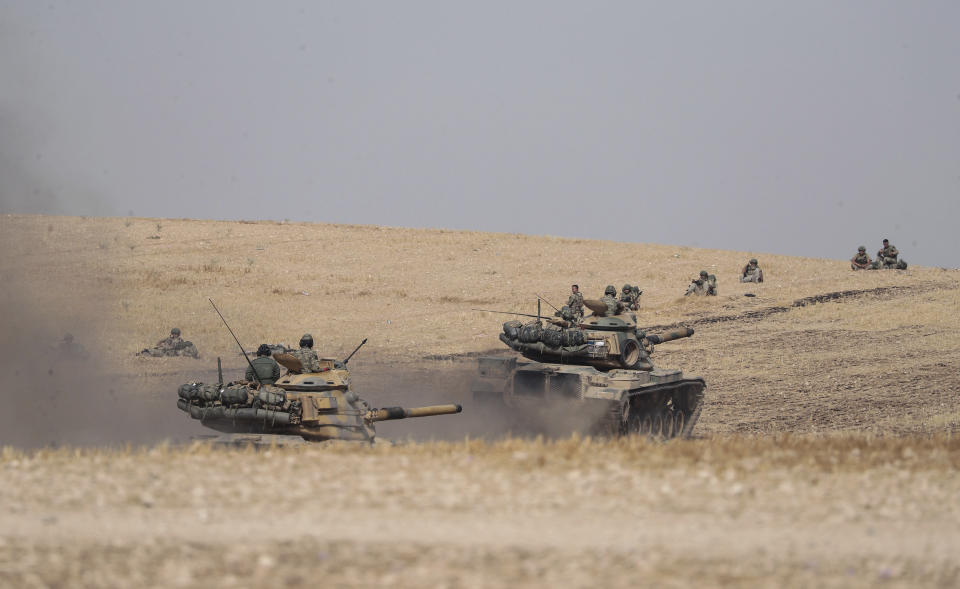 Turkish tanks and troops stationed near Syrian town of Manbij, Syria, Tuesday. Oct. 15, 2019. Russia moved to fill the void left by the United States in northern Syria on Tuesday, deploying troops to keep apart advancing Syrian government and Turkish forces.(Ugur Can/DHA via AP)