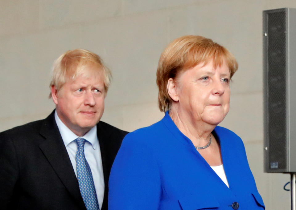 Britain's Prime Minister Boris Johnson and German Chancellor Angela Merkel are seen ahead of their news conference at the Chancellery in Berlin, Germany August 21, 2019. REUTERS/Fabrizio Bensch