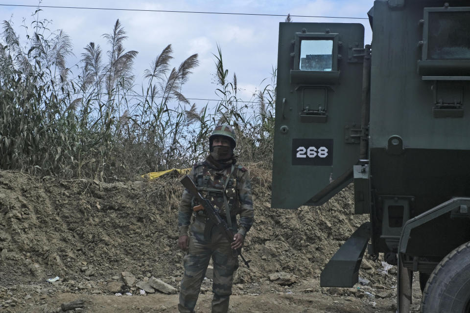 An Indian army soldier stands guard on a highway on the outskirts of Kohima, capital of northeastern Nagaland state, India, Sunday, Dec. 5, 2021. Angry villagers burned army vehicles in protest after more than a dozen people were killed by Indian army soldiers who mistakenly believed some of them were militants in Nagaland state, along the border with Myanmar, about 300 kilometers (186 miles) from here. Nagaland state’s top elected official ordered a probe into the killings, which occurred on Saturday. (AP Photo/Yirmiyan Arthur)