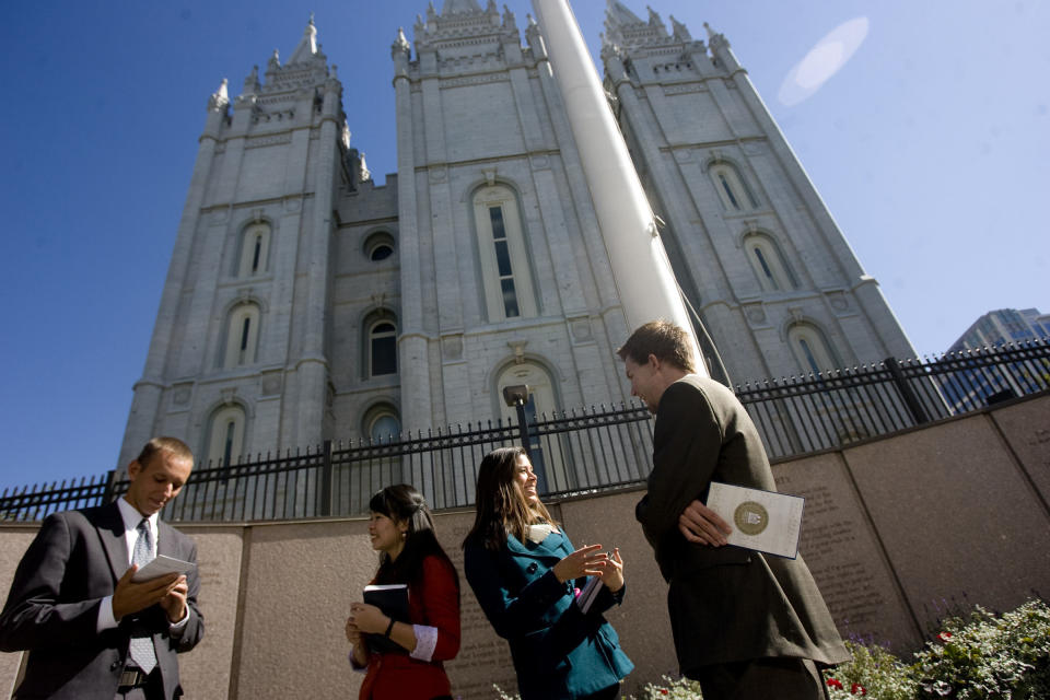 Missionaries Sister Khanitta Puttapong, center left, and Sister Christina Wong, center right, talk to Casey Ahlstrom, left, and Jason Mondon in Temple Square during the 182nd Semiannual General Conference of the Church of Jesus Christ of Latter-day Saints in Salt Lake City on Sunday, Oct, 7, 2012. (AP Photo/The Salt Lake Tribune, Kim Raff)