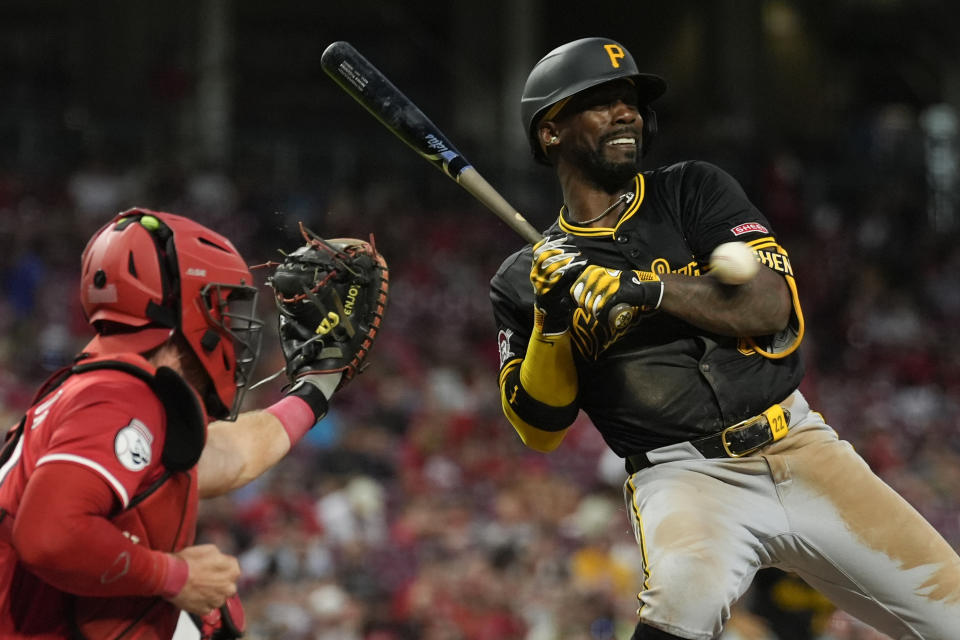 Pittsburgh Pirates' Andrew McCutchen is hit by a Cincinnati Reds pitch during the sixth inning of a baseball game Tuesday, June 25, 2024, in Cincinnati. Reds catcher Tyler Stephenson is left. (AP Photo/Carolyn Kaster)