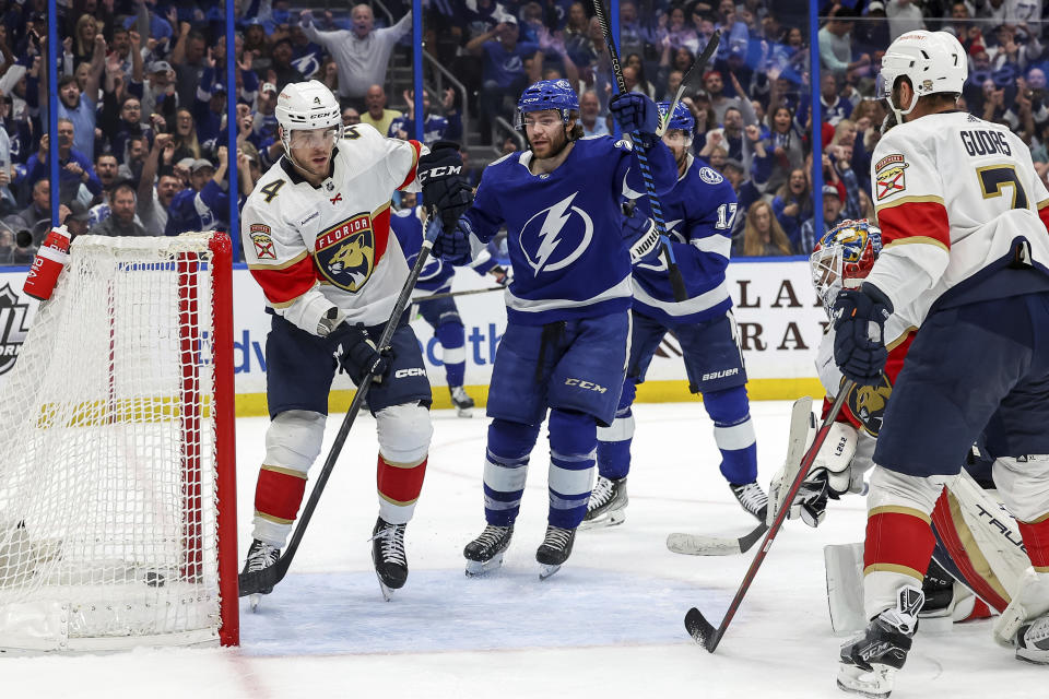 Tampa Bay Lightning's Brayden Point celebrates his goal, between Florida Panthers' Casey Fitzgerald (4) and Radko Gudas, during the second period of an NHL hockey game Tuesday, Feb. 28, 2023, in Tampa, Fla. (AP Photo/Mike Carlson)