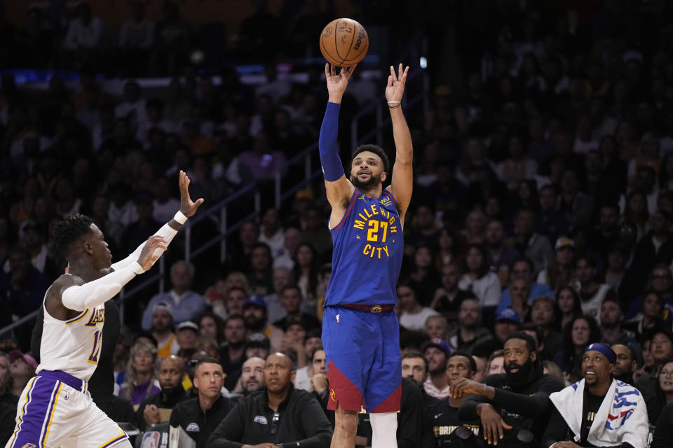 Denver Nuggets guard Jamal Murray (27) shoots over Los Angeles Lakers guard Dennis Schroder in the first half of Game 3 of the NBA basketball Western Conference Final series Saturday, May 20, 2023, in Los Angeles. (AP Photo/Mark J. Terrill)