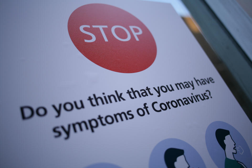 A notice instructs people with symptoms of the covid-19 coronavirus not to enter St Mary's Hospital in London, England, on March 11, 2020. The hospital houses a dedicated 'coronavirus pod' isolation unit for symptomatic patients. In the UK, 460 people have now been confirmed to have the virus. Six patients with coronavirus have so far died in hospitals around the country. The World Health Organisation (WHO) meanwhile today officially designated the global spread of the illness as a pandemic. (Photo by David Cliff/NurPhoto via Getty Images)