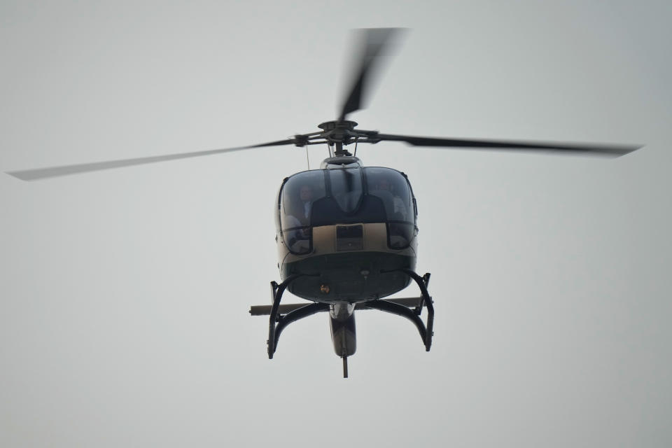 A helicopter carrying Pakistan's former Prime Minister Nawaz Sharif arrives to address a welcoming rally, in Lahore, Pakistan, Saturday, Oct. 21, 2023. Sharif returned home Saturday on a special flight from Dubai, ending four years of self-imposed exile in London as he seeks to win the support of voters ahead of parliamentary elections due in January. Sharif is expected to address a massive homecoming rally in the eastern city of Lahore on Saturday evening and his return comes as Pakistan is experiencing deepening political turmoil and one of its worst economic crises. (AP Photo/Anjum Naveed)