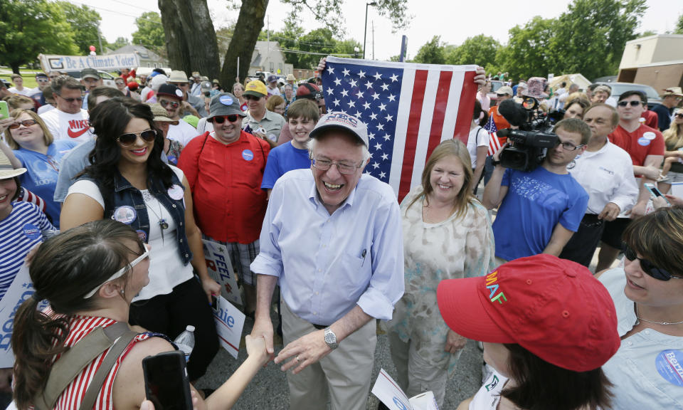 Sen. Bernie Sanders greets local residents before walking in a Fourth of July parade on Saturday, July 4, 2015, in Waukee, Iowa. 