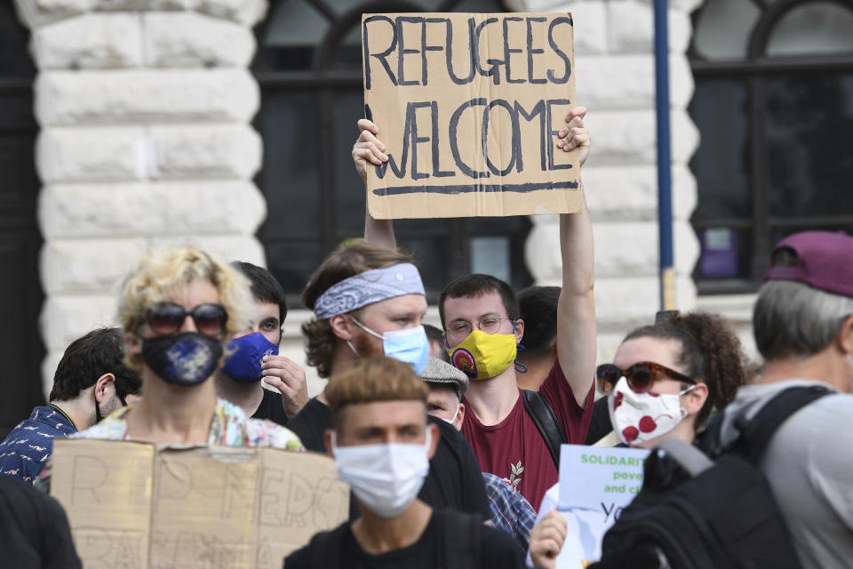 Pro-migrant supporters gather during a 'solidarity stand' in Dover's Market Square in support of the refugees crossing the Channel to Kent, in Dover, England, Saturday, Sept. 5, 2020. (Stefan Rousseau/PAvia AP)