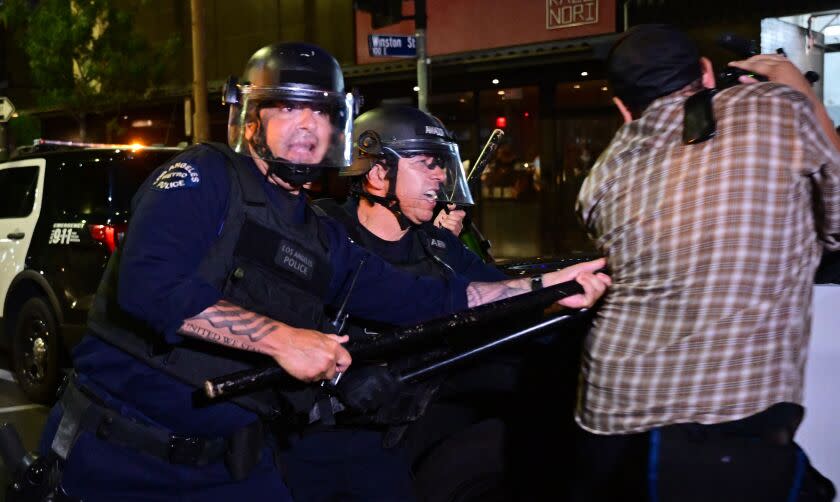 Police holding batons move to disperse a crowd of abortion rights activists protesting after the overturning of Roe Vs. Wade by the US Supreme Court, in Downtown Los Angeles, on June 24, 2022. - The US Supreme Court on Friday struck down the right to abortion in a seismic ruling that shredded five decades of constitutional protections and prompted several right-leaning states to impose immediate bans on the procedure. (Photo by Frederic J. BROWN / AFP) (Photo by FREDERIC J. BROWN/AFP via Getty Images)