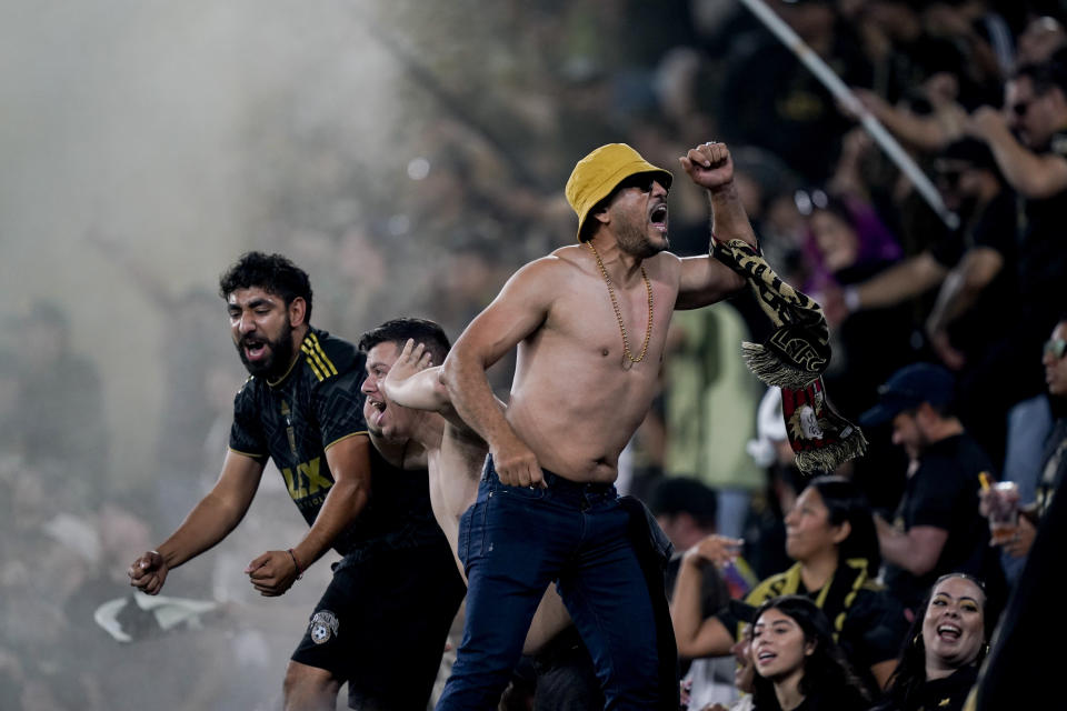 Fans celebrate after a goal by Los Angeles FC midfielder Ryan Hollingshead against the Vancouver Whitecaps during the second half of an MLS playoff soccer match Saturday, Oct. 28, 2023, in Los Angeles. (AP Photo/Ryan Sun)