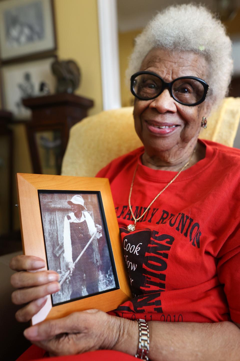 Ora Jackson, 99, holds a photo of her father Virge Cooley as she sits in the family living room of their home on Friday, June, 11, 2021. Jackson's life history makes clear that slavery in the United States does not belong to the ancient past. For her, slavery is an experience that directly touched her father's life, her own, and influenced those of her children and grandchildren.