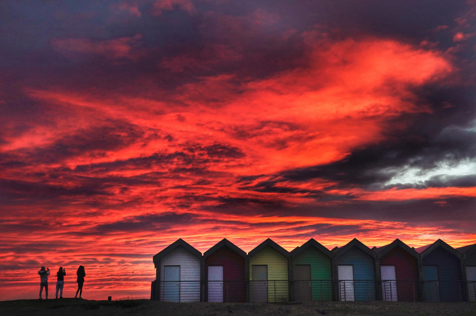 Colourful beach huts stand in front of the stunning red sky at sunrise in Blyth, Northumberland. Picture date: Tuesday February 23, 2021. (Photo by Owen Humphreys/PA Images via Getty Images)