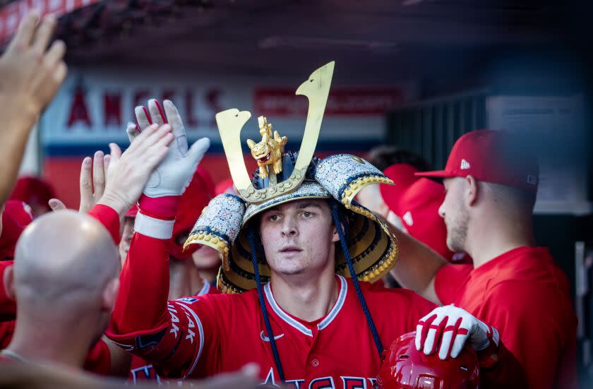 Anaheim, CA - July 18: Angels center fielder Mickey Moniak #16 is congratulated in the dugout after hitting a two-run home run in the first inning against the Yankees at Angel Stadium in Anaheim Tuesday, July 18, 2023. (Allen J. Schaben / Los Angeles Times)