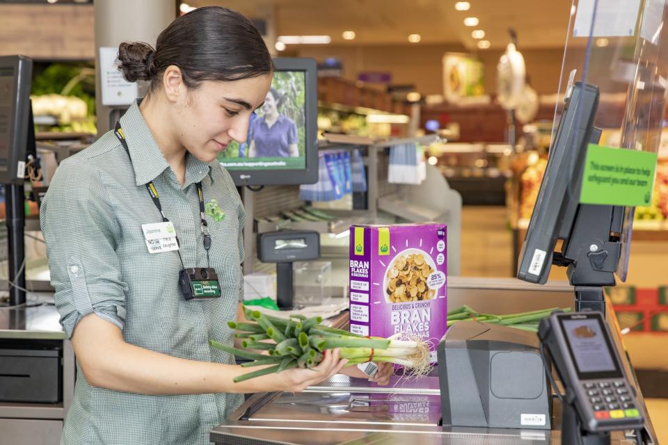 Woolworths staff member Jasmine Sakoua is pictured wearing a body camera at the Rosehill store.