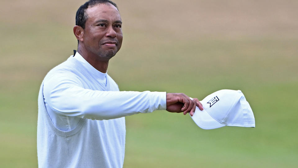 Tiger Woods waves to fans at the British Open.