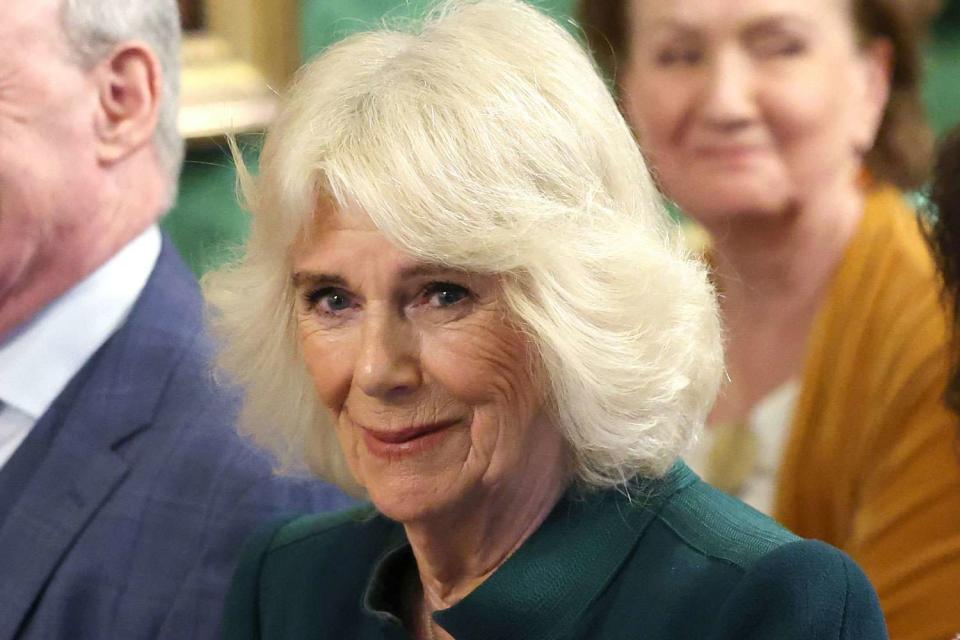 <p>Chris Jackson - Pool/Getty </p> Queen Camilla smiles as she attends the "Northern Ireland: Poets and Their Place" at Hillsborough Castle during her visit to Northern Ireland on March 21, 2024. 