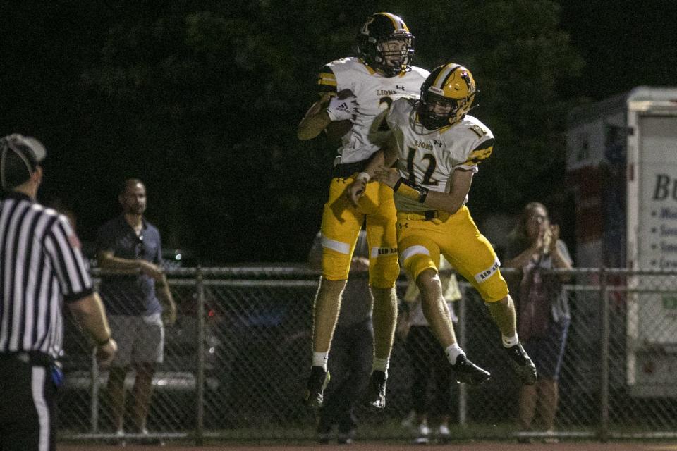 Red Lion's Garrett Coppersmith, left, celebrates scoring a touchdown with teammate Mason Hollingshead. Red Lion defeated West York, 45-32, in football at West York Area High School, Friday, September 2, 2022.