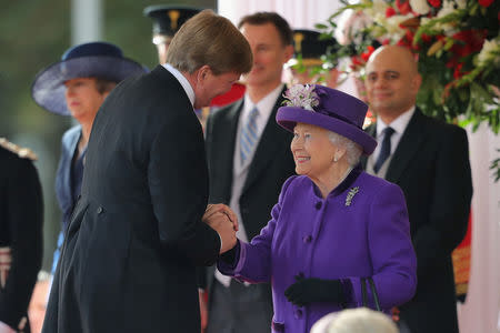 Britain's Queen Elizabeth greets King Willem-Alexander of the Netherlands during a ceremonial welcome at the start of a state visit by King Willem-Alexander and Queen Maxima of the Netherlands at Horse Guards Parade, in London, Britain October 23, 2018. Christopher Furlong/Pool via REUTERS