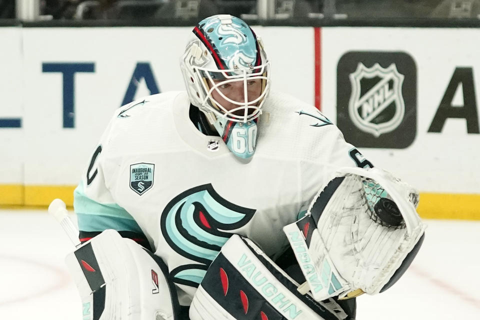 Seattle Kraken goaltender Chris Driedger makes a glove save during the second period of an NHL hockey game against the Los Angeles Kings Monday, March 28, 2022, in Los Angeles. (AP Photo/Mark J. Terrill)