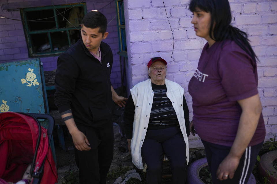 Local residents gather outside their heavily damaged house after a Russian strike in Pokrovsk, eastern Ukraine, Wednesday, May 25, 2022. Two rockets struck the eastern Ukrainian town of Pokrovsk, in the Donetsk region early Wednesday morning, causing at least four injuries. (AP Photo/Francisco Seco)