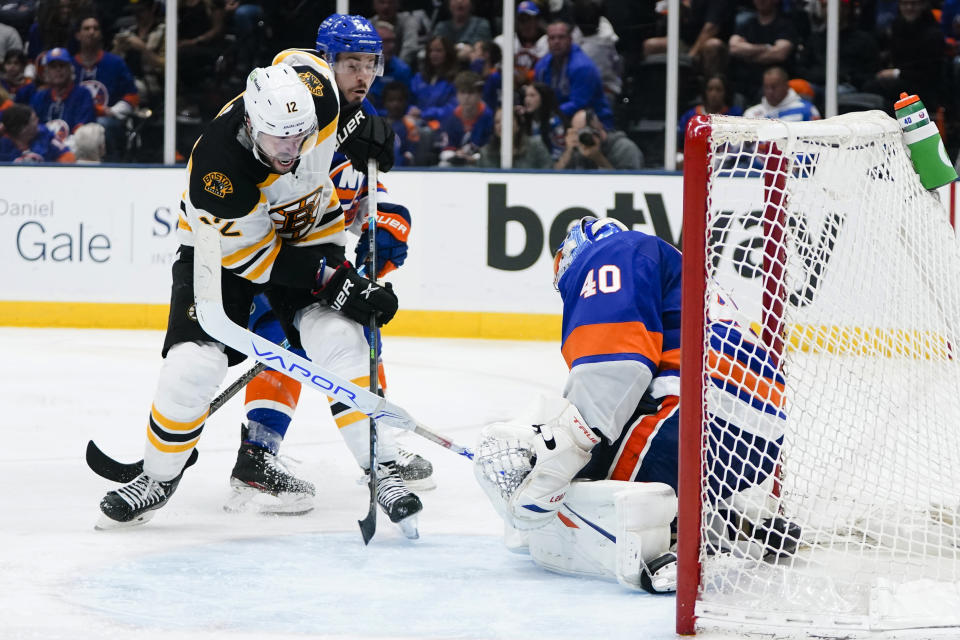 New York Islanders goaltender Semyon Varlamov (40) stops a shot by Boston Bruins' Craig Smith (12) during the third period of Game 3 during an NHL hockey second-round playoff series Thursday, June 3, 2021, in Uniondale, N.Y. (AP Photo/Frank Franklin II)