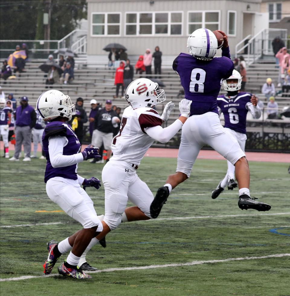 New Rochelle's Corey Dawson pulls down an interception  against Scarsdale, during their football game at New Rochelle High School, Oct. 1, 2022. 