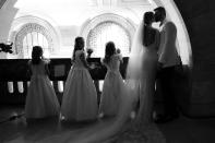 <p>The couple and their flower girls share a private moment watching their guests enjoy a children's gospel choir. </p>