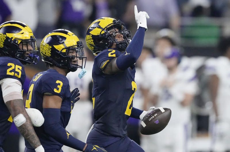 Michigan Wolverines defensive back Will Johnson (R) celebrates after intercepting a pass from Washington Huskies quarterback Michael Penix Jr. in the third quarter during the 2024 College Football Playoff final Monday at NRG Stadium in Houston. Photo by Kevin M. Cox/UPI