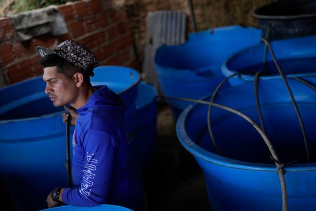 Franklin Caceres fills up tanks with water which it pumps from a groundwater well in the Petare neighborhood of Caracas, Venezuela on Monday. Caceres supplies water to more than 400 people in the upper sector of Petare (Copyright 2023 The Associated Press. All rights reserved)