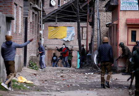 Kashmiri demonstrators (C) throw stones towards Indian policemen during a protest against by-polls in Srinagar April 9, 2017. REUTERS/Danish Ismail