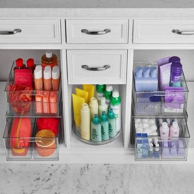 the bathroom organization set holding various bathroom essentials in a vanity