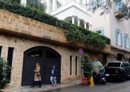 People walk past a house that is believed to belong to Carlos Ghosn in Beirut