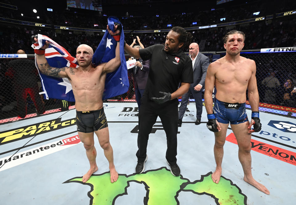 Alexander Volkanovski (pictured left) has his hand raised after he won his fight over Brian Ortega (pictured right) in their UFC featherweight championship fight during the UFC 266 event.