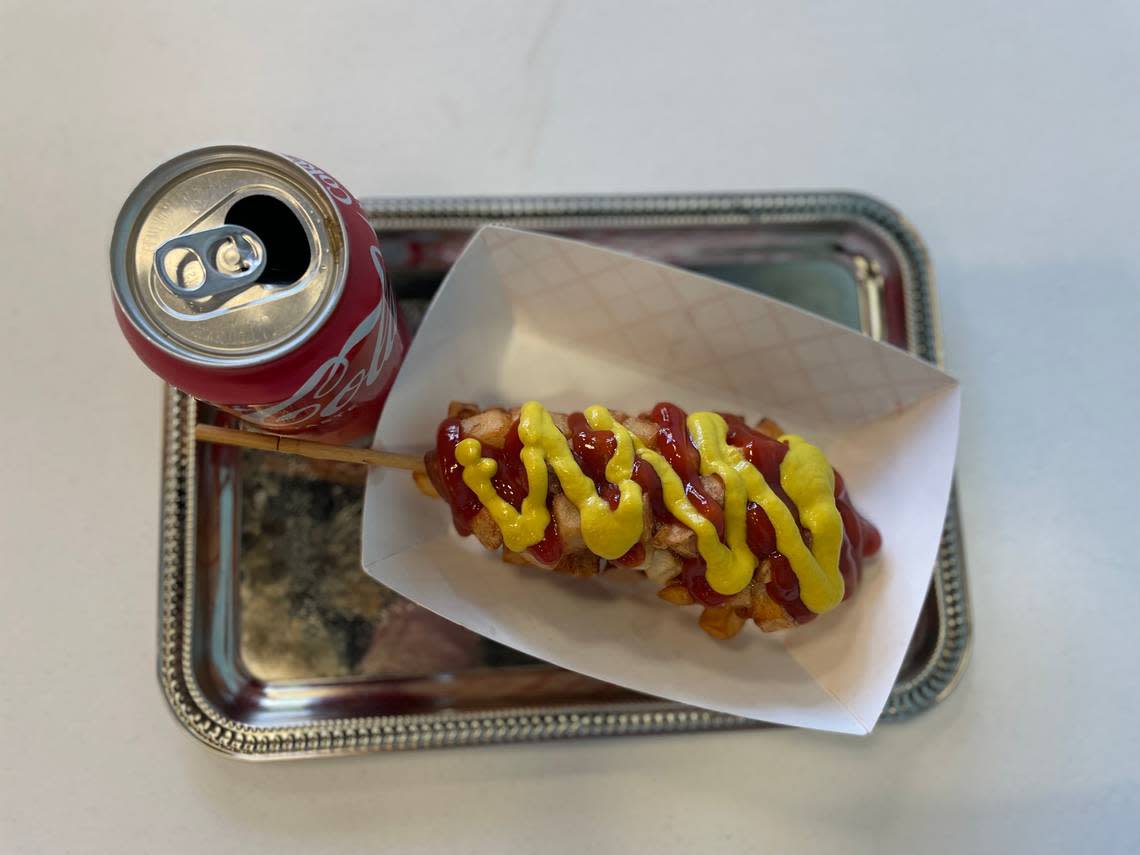 A Korean corn dog goes well with a Coke at Koco Bell.