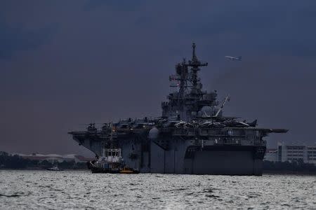 U.S Navy's USS America, which is supporting ongoing search for missing crew members of USS John McCain, is seen in Singapore waters, August 21, 2017. Ariffin Jamar/The Straits Times via REUTERS