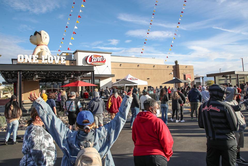 A large line of people wait for the opening of Raising Cane's Chicken Fingers in Palm Springs, January 13, 2022.