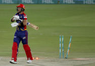 Karachi Kings' Colin Ingram walks back to pavilion while he bowled out by Lahore Qalandars' Ahmed Daniyal during a Pakistan Super League T20 cricket match between Karachi Kings and Lahore Qalandars at the National Stadium, in Karachi, Pakistan, Sunday, Feb. 28, 2021. (AP Photo/Fareed Khan)