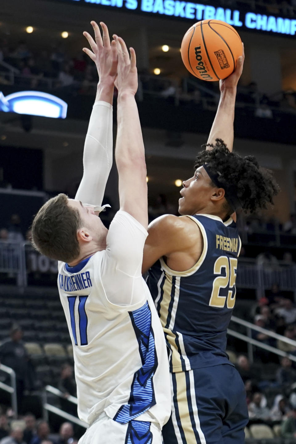 Akron's Enrique Freeman shoots against Creighton's Ryan Kalkbrenner during the first half of a college basketball game in the first round of the NCAA men's tournament Thursday, March 21, 2024, in Pittsburgh. (AP Photo/Matt Freed)