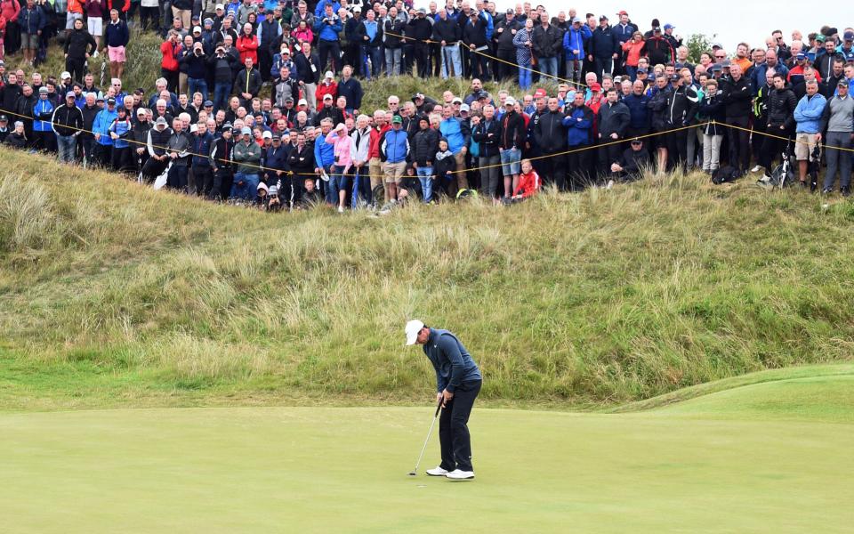 Rory McIlroy of Northern Ireland sinks a putt during the second round of the British Open Golf Championship at Royal Birkdale - Credit: EPA