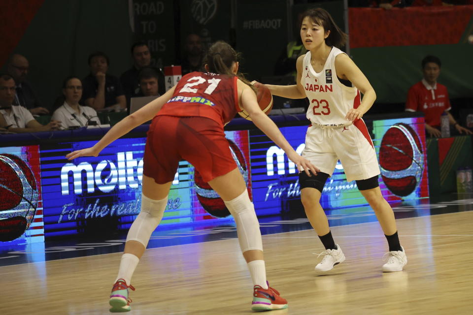 Mai Yamamoto, right, of Japan is blocked by Reka Lelik of Hungary during the women's basketball Olympic qualifying tournament second round match between Japan and Hungary in Sopron, Hungary, Friday, Feb. 9, 2024. (Zsombor Toth/MTI via AP)