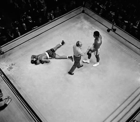 <p>Referee John LoBianco directs champion Muhammad Ali to a neutral corner before he started the knockout count over prostrate challenger Zora Folley in seventh round of heavyweight little fight. Ali was declared victor on a knockout at 1:48 of the round in fight in New York’s Madison Square Garden, March 22, 1967. (AP Photo)</p>
