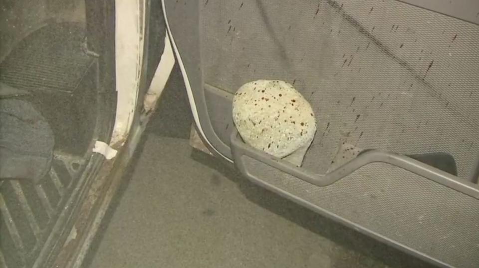 The rock that authorities say struck White is seen resting in a pocket along the car's door, which is splattered with blood. (Photo: Genesee County Prosecutors Office)