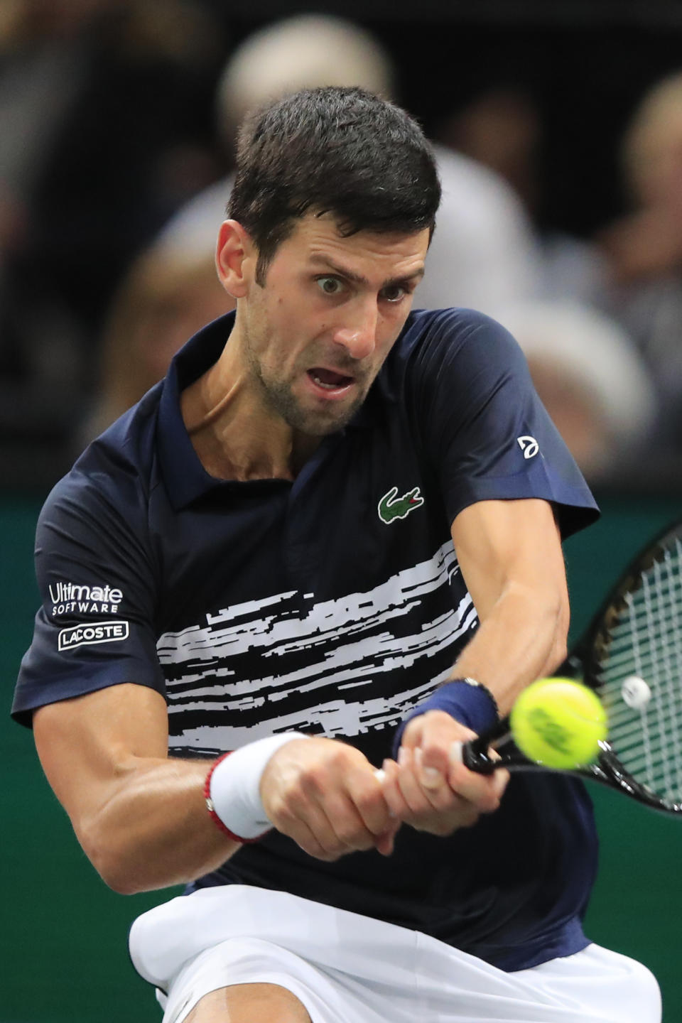 Serbia's Novak Djokovic returns the ball to Greece's Stefanos Tsitsipas in a quarterfinal match of the Paris Masters tennis tournament Friday, Nov. 1, 2019 in Paris. (AP Photo/Michel Euler)