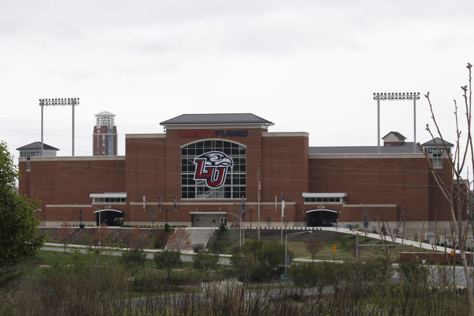 Liberty University's football stadium is empty as students were welcomed back to the university's campus, Tuesday March 24 , 2020, in Lynchburg, Va. Officials in Lynchburg, said Tuesday they were fielding complaints and concerns about the hundreds of students that have returned from their spring break to Liberty University, where President Jerry Falwell Jr. has welcomed them back amid the coronavirus pandemic. (AP Photo/Steve Helber)