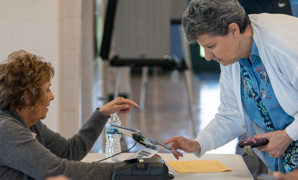 Election worker Jayne Docherty (left), helps voter Carla Strommen check in the polls at Roy G. Holland Park, Fishers, Wednesday, April 27, 2022, less than a week from Indiana primary election day. About 20 people came in during the first half hour, and workers there said interest is picking up prior to May 3. 