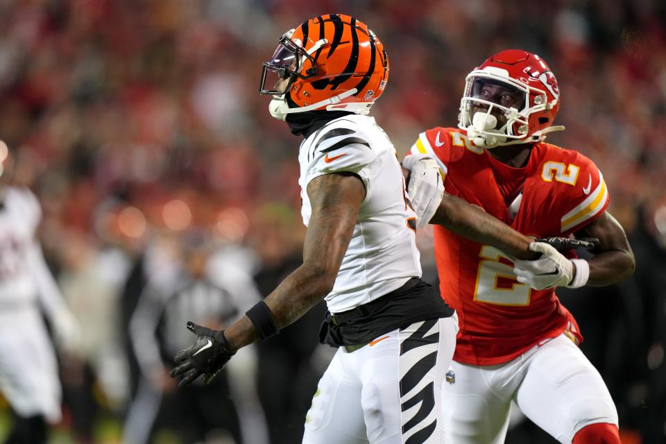 Kansas City Chiefs cornerback Joshua Williams grabs the arm of Cincinnati Bengals wide receiver Tee Higgins